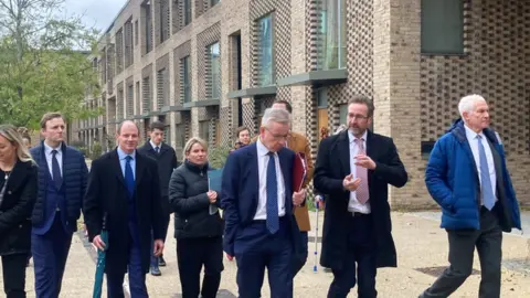 Mousumi Bakshi /BBC Group of people walking towards the camera