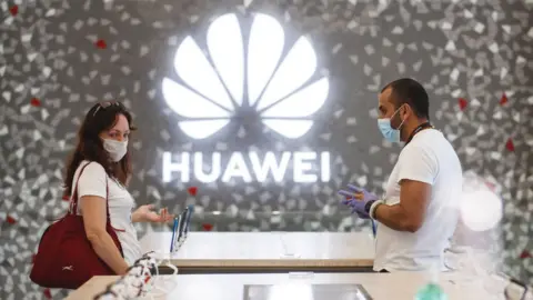 Getty Images People shop at a Huawei store in Barcelona, Spain