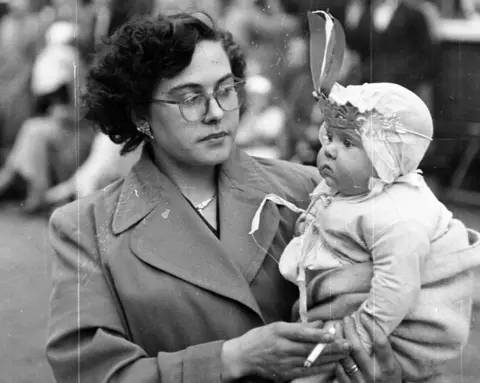 Getty Images Residents of Morpeth Street in London's East End wear costumes at a street party to celebrate the coronation of Queen Elizabeth II