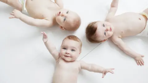 Getty Images Babies lying on the floor