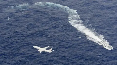 Reuters US Navy aircraft and a Japanese vessel take part in the rescue operation. Photo: 6 December 2018