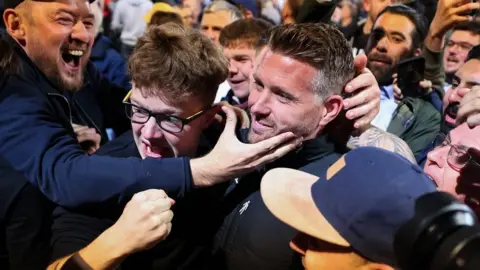 Getty Images Rob Edwards celebrate with Luton fans