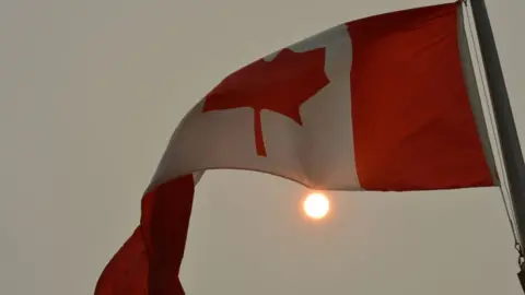 Getty Images Canadian flag and hazy sun