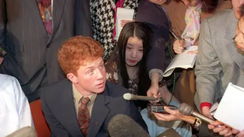 AFP/Getty Webb Haymaker, centre, talking to Japanese reporters on a trip to Japan in 1994