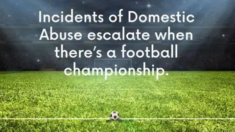 Kent County Council A CGI image of a football stadium with green grass and a football on the halfway line with writing that says: "Incidents of domestic abuse escalate when there's a football championship".