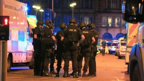 PA Media Armed Police officers at Manchester Arena