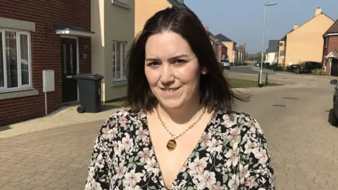 Sam Read/BBC India Marshall-Roads, a mother, standing in a road