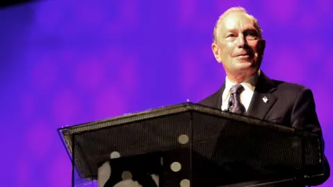 Getty Images Michael Bloomberg speaking at a podium at the Christian Cultural Centre in Brooklyn