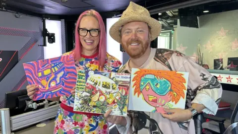 Sarah Graham Sarah Graham and Keith Lemon holding up three paintings