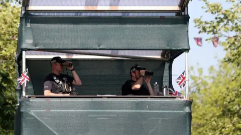 Getty Images Police officers standing in a make-shift tower