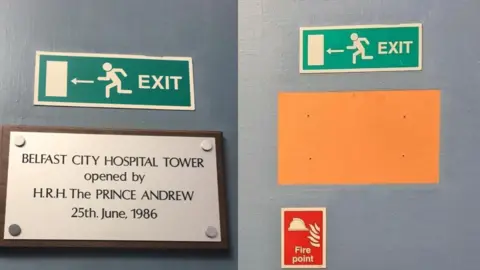 Other The plaque at Belfast City Hospital which reads 'Belfast City Hospital Tower opened by H.R.H. the Prince Andrew 25th June 1986', and right, an orange square on a dark grey wall after it was removed