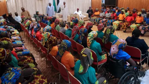 AFP Nigeria"s President Muhammadu Buhari (L) addresses the 82 rescued Chibok girls during a reception ceremony at the Presidential Villa in Abuja, on May 7, 2017.