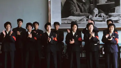Getty Images Red Guards applauding in front of Mao Zedong's portrait