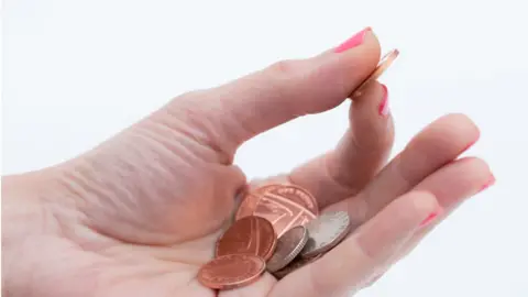 Getty Images Woman's hand holding money