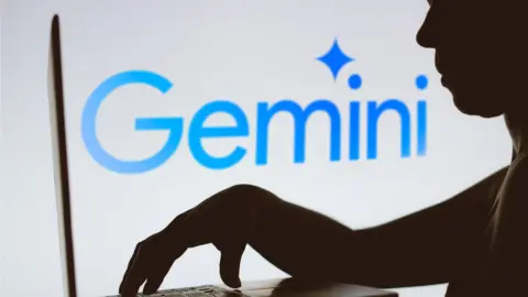 The Google Gemini logo in the background of a silhouette of a person using a laptop.