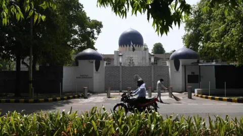 AFP A motorist rides past the main gate of the Pakistan High Commission in Delhi, 1 June