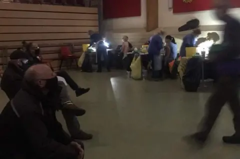 Millfield Surgery/Lorraine Boyd People getting booster jabs by torch light