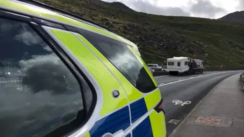 North Wales Police Caravan on a tow truck and police car