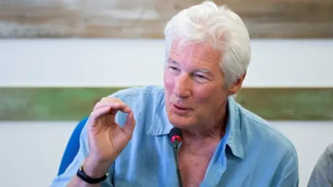 EPA Richard Gere speaking during a press conference on the island of Lampedusa, 10 August 2019