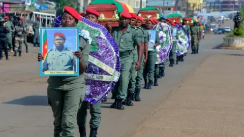 Getty Images Soldiers carry the coffins of the four soldiers killed in the violence that erupted in the Northwest and Southwest Regions of Cameroon, where most of the country's English-speaking minority live, during a ceremony in Bamenda on November 17, 2017