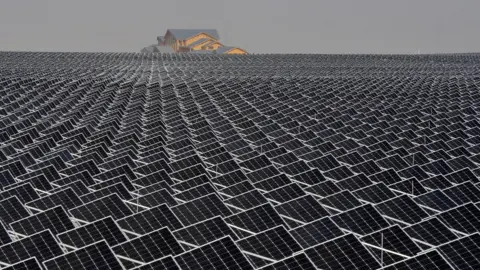 Reuters Solar panels are seen in Yinchuan, Ningxia Hui Autonomous Region, China. House in the distance
