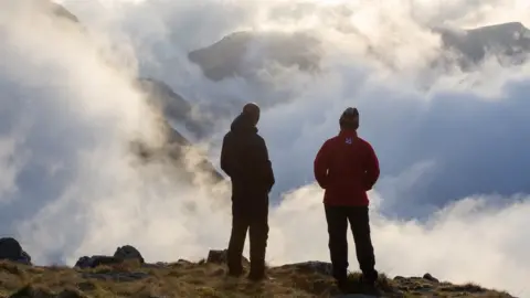 Tom White/Getty Images People atop Scafell Pike