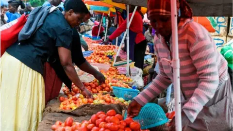 AFP Women at a food market in Kenya