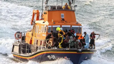 Reuters People being brought ashore in a RNLI boat