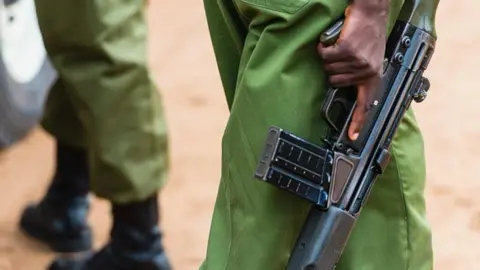 Getty Images Kenyan police officer with gun