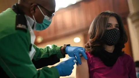 Getty Images A woman gets her Covid booster in west London