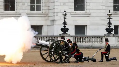 Reuters A gun salute at the ceremony in London