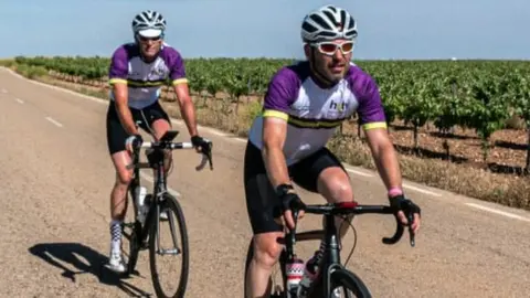 Two cyclists taking part in a bike ride