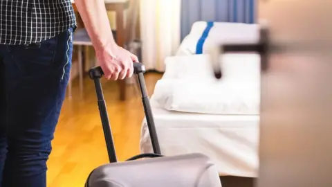 Getty Images Tourist in hotel room