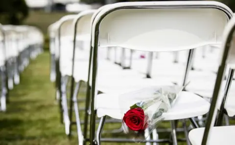 EPA White chairs and red roses are set up by relatives of crash victims of flight MH17 as a silent protest in front of the Russian embassy in The Hague, The Netherlands, 8 May 2018