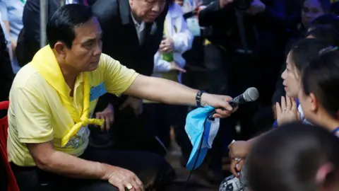 Reuters The prime minister holds microphone for relative as he listens to her at an event