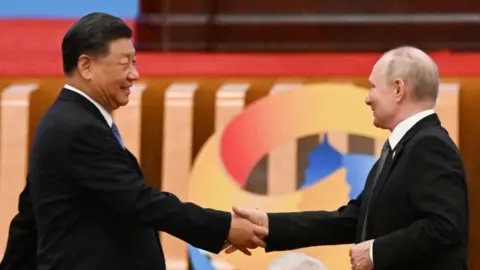 Russia's President Vladimir Putin and Chinese President Xi Jinping shake hands during the opening ceremony of the third Belt and Road Forum in Beijing on October 18, 2023.