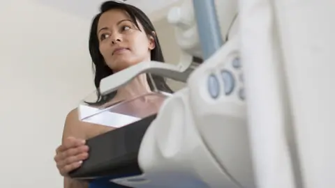 Getty Images Patient having mammograph