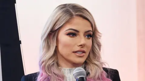 Jamie McCarthy Alexa Bliss speaking at an event