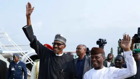 Reuters President Buhari and his deputy, Yemi Osinbajo, wave as they arrive in Abuja