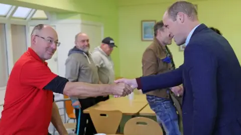 PA Media The Prince of Wales meets staff and service users at the Rainbow Centre
