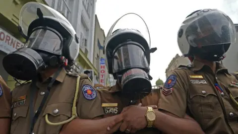 Getty Images Sri Lankan police during a protest in Colombo on 6 July 2022.