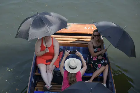 Martin Dalton/REX/Shutterstock Women on a punt on the River Cam