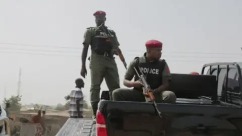 ATV News Nigerian police at the scene of the mosque attack in north-east Nigeria, 1 May 2018