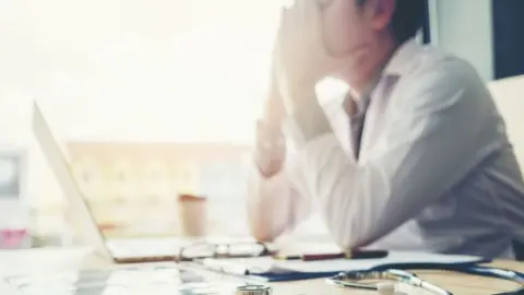 Getty Images Stressed doctor
