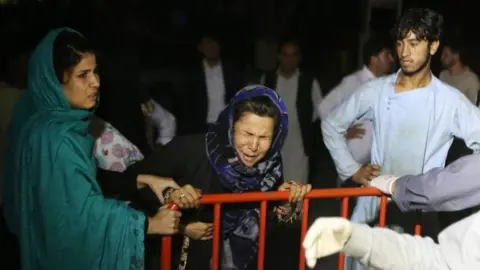 EPA A woman cries outside a hospital after the blast