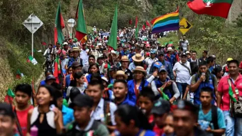 AFP Members of the indigenous Nasa group marching the municipality of Toribio, Cauca department, on their way to attend the National Meeting of Indigenous Guards on 11 October 11, 2019.