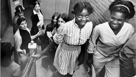 Boston Globe/Getty Images Black and white female students in school