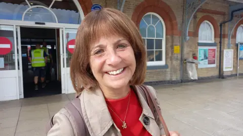 Belinda Moore in front of Ipswich rail station