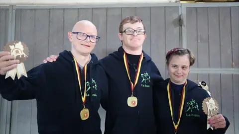 Alberto, Michele and Antinisca holding medals and trophies