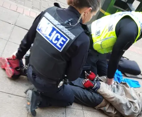 James Martin Man on the floor handcuffed by officers